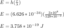 E = h(\frac{c}{\lambda} )\\\\E =(6.626*10^{-34})(\frac{3*10^8}{529*10^{-9}} )\\\\E = 3.758 *10^{-19} \ J