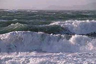 The coastal region upon which the waves in the following image are breaking most likely has a