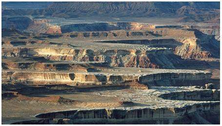 What elevated, flat-topped land forms are shown in the above picture?