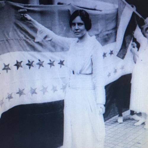 Based on the photograph, what is Alice Paul celebrating?

O the passage of the Pure Food and Drug