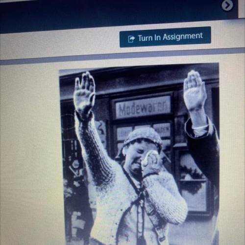 1. This photo shows a Czechoslovakian woman making a special gesture as she watches German

troops