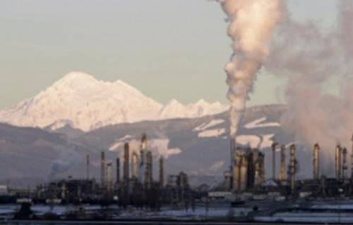 The image shows an oil refinery in Washington.

Which best explains how this refinery is affecting