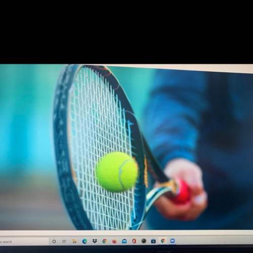 In 1 to 2 sentences analyze what type of collision occurs when a tennis racket hits a ball as shown